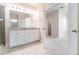 Bright bathroom featuring dual sinks, granite countertop, modern fixtures, and a tiled shower at 1997 Standing Rock Cir, Oakland, FL 34787