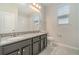 Bathroom with double vanity, granite countertops, modern lighting and a large mirror at 1997 Standing Rock Cir, Oakland, FL 34787