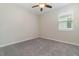 Neutral bedroom featuring gray carpeting, ceiling fan, and a white door at 1997 Standing Rock Cir, Oakland, FL 34787
