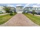 Modern two-story home with a paver driveway and well-manicured lawn at 1997 Standing Rock Cir, Oakland, FL 34787