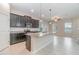 Modern kitchen featuring an island, granite countertops, stainless steel appliances, and ample storage at 1997 Standing Rock Cir, Oakland, FL 34787