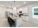 Bright kitchen features white cabinets, stainless steel appliances, granite countertops, and a large island with seating at 1997 Standing Rock Cir, Oakland, FL 34787