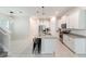 Bright kitchen features white cabinets, stainless steel appliances, granite countertops, and a large island with seating at 1997 Standing Rock Cir, Oakland, FL 34787