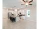View of the kitchen and eating area, highlighting an open-concept layout with tile flooring and a ceiling fan at 1997 Standing Rock Cir, Oakland, FL 34787