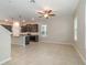 Bright open-concept kitchen and living space with stainless steel appliances, and tile flooring at 1997 Standing Rock Cir, Oakland, FL 34787