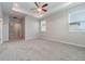 Spacious carpeted main bedroom with recessed ceiling, ceiling fan, and lots of natural light at 1997 Standing Rock Cir, Oakland, FL 34787