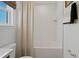 Bright bathroom with a combination tub and shower featuring white subway tiles and a neutral shower curtain at 2054 Education St, St Cloud, FL 34771