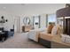 Bright, spacious bedroom with dresser and views of nature through the windows at 2054 Education St, St Cloud, FL 34771