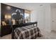 Well-appointed bedroom with a football theme, a spacious layout, and abundant natural light from a large window at 2054 Education St, St Cloud, FL 34771
