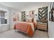 Stylish bedroom with a large window, patterned drapes, and colorful decor on built-in shelves at 2054 Education St, St Cloud, FL 34771