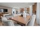 Open-concept living space with a dining area featuring a wooden table and comfortable upholstered chairs at 2054 Education St, St Cloud, FL 34771