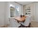 Elegant dining area with a wooden table, comfortable upholstered chairs, and natural light from the window at 2054 Education St, St Cloud, FL 34771
