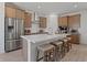 Beautiful kitchen boasts stainless appliances, a spacious island with seating, and stylish wooden cabinetry at 2054 Education St, St Cloud, FL 34771