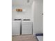 Bright laundry room features modern side by side appliances and wire shelving at 2054 Education St, St Cloud, FL 34771