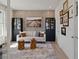 Inviting living room with wood-look accent wall, neutral sofa, and decorative shelving at 2054 Education St, St Cloud, FL 34771