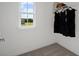 Walk-in closet with carpet flooring, wire shelving, and window offering natural light and outdoor views at 2054 Education St, St Cloud, FL 34771