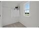 Walk-in closet with carpet flooring, wire shelving, and window offering natural light and outdoor views at 2054 Education St, St Cloud, FL 34771