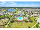 Community aerial view featuring a large swimming pool, modern clubhouse, scenic walking trails, and Gathering recreation areas at 2223 Blue Salvia St, Clermont, FL 34711