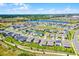 Beautiful aerial view of a residential community with a lake and green spaces at 2223 Blue Salvia St, Clermont, FL 34711