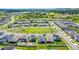 Aerial view of a residential neighborhood featuring green spaces and community amenities at 2223 Blue Salvia St, Clermont, FL 34711