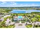 Aerial shot of a community showcasing a resort-style pool, clubhouse, playground, and meticulously landscaped grounds at 2223 Blue Salvia St, Clermont, FL 34711