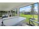 Screened back patio featuring a hot tub and seating area with backyard views at 2223 Blue Salvia St, Clermont, FL 34711