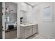 Bright bathroom featuring double sinks and a view of the bedroom through an open doorway at 2223 Blue Salvia St, Clermont, FL 34711