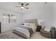 Serene bedroom with a tufted headboard, plantation shutters, and a cozy reading nook at 2223 Blue Salvia St, Clermont, FL 34711