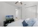 Cozy bedroom with a ceiling fan, closet, and a TV, providing a relaxing retreat at 2223 Blue Salvia St, Clermont, FL 34711