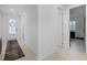 Hallway featuring a neutral color palette, tile floors, and a decorative entry door at 2223 Blue Salvia St, Clermont, FL 34711