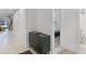 Bright hallway with a decorative entry door, tile flooring, and modern cabinet at 2223 Blue Salvia St, Clermont, FL 34711