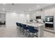 Spacious kitchen featuring a large island with barstool seating and modern stainless steel appliances at 2223 Blue Salvia St, Clermont, FL 34711