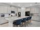 Bright kitchen with a large center island, seating, modern appliances, and ample storage cabinets at 2223 Blue Salvia St, Clermont, FL 34711