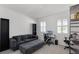 Comfortable living room featuring a dark gray couch and office space with lots of natural light at 2223 Blue Salvia St, Clermont, FL 34711