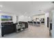 Open concept living space featuring a modern kitchen with barstool seating flowing into a comfortable living area at 2223 Blue Salvia St, Clermont, FL 34711