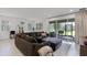 Comfortable living room featuring a large sectional sofa and a view of the backyard through sliding glass doors at 2223 Blue Salvia St, Clermont, FL 34711