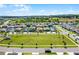View of the property from above showcasing the neighborhood, front yard and nearby green space at 2223 Blue Salvia St, Clermont, FL 34711