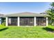 Enclosed back patio featuring outdoor seating with a hot tub and privacy at 2223 Blue Salvia St, Clermont, FL 34711