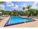 Community pool features a spacious sun deck with lounge chairs and tables at 242 Peppertree Ct, Lake Mary, FL 32746