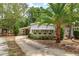 Charming home featuring an enclosed porch with sunshades and a convenient carport at 242 Peppertree Ct, Lake Mary, FL 32746