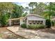 Inviting home featuring an enclosed porch with sunshades and a convenient carport at 242 Peppertree Ct, Lake Mary, FL 32746