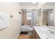 Bathroom featuring tile, vanity and bathtub with curtain, offering a functional space at 244 Angeles Rd, Debary, FL 32713