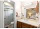 Modern bathroom with a glass-enclosed shower, sleek vanity, and a view of the bedroom at 244 Angeles Rd, Debary, FL 32713