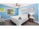 A cozy bedroom featuring soft blue walls and natural light filtering through the windows at 244 Angeles Rd, Debary, FL 32713
