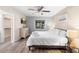 Brightly lit bedroom featuring a ceiling fan, natural light, and sleek gray flooring at 244 Angeles Rd, Debary, FL 32713