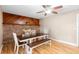 Bright dining area with a unique brick accent wall, laminate flooring and modern lighting at 244 Angeles Rd, Debary, FL 32713