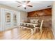 Cozy dining room with bench seating, brick accent wall, and laminate flooring at 244 Angeles Rd, Debary, FL 32713