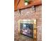 A beautiful brick fireplace with brass trim and mantel, complete with burning logs at 244 Angeles Rd, Debary, FL 32713