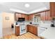 Functional kitchen with white countertops, wood cabinetry, and modern appliances at 244 Angeles Rd, Debary, FL 32713