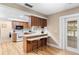 Cozy kitchen with breakfast bar, wood-look flooring, and convenient access to other rooms at 244 Angeles Rd, Debary, FL 32713